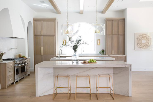 Modern custom kitchen island with marble countertop, built-in storage, and elegant cabinetry for functional kitchen design.